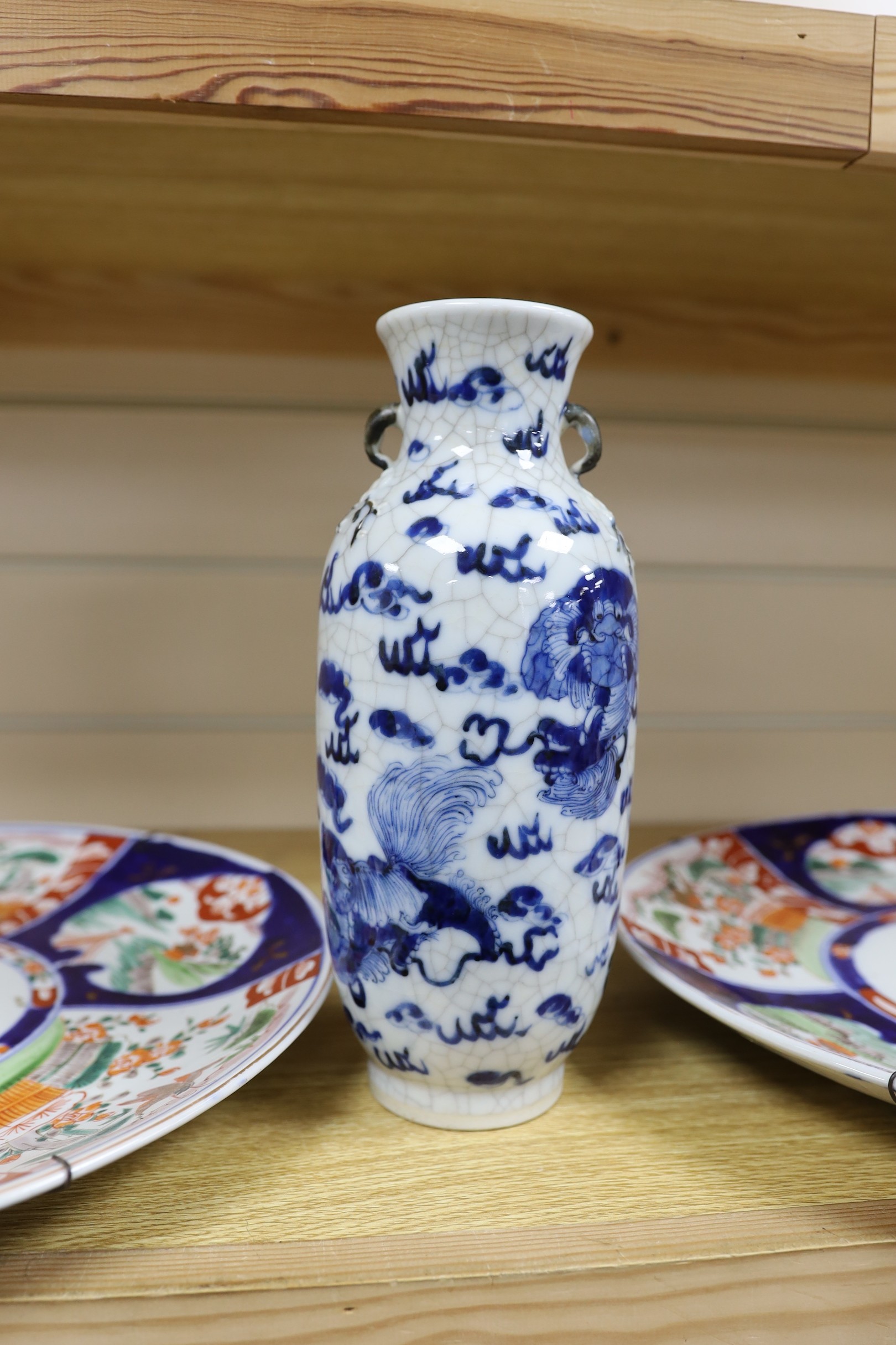 A Chinese two handled crackle glaze vase, Kangxi mark, but late 19th century, together two Imari plates, 37cm diameter